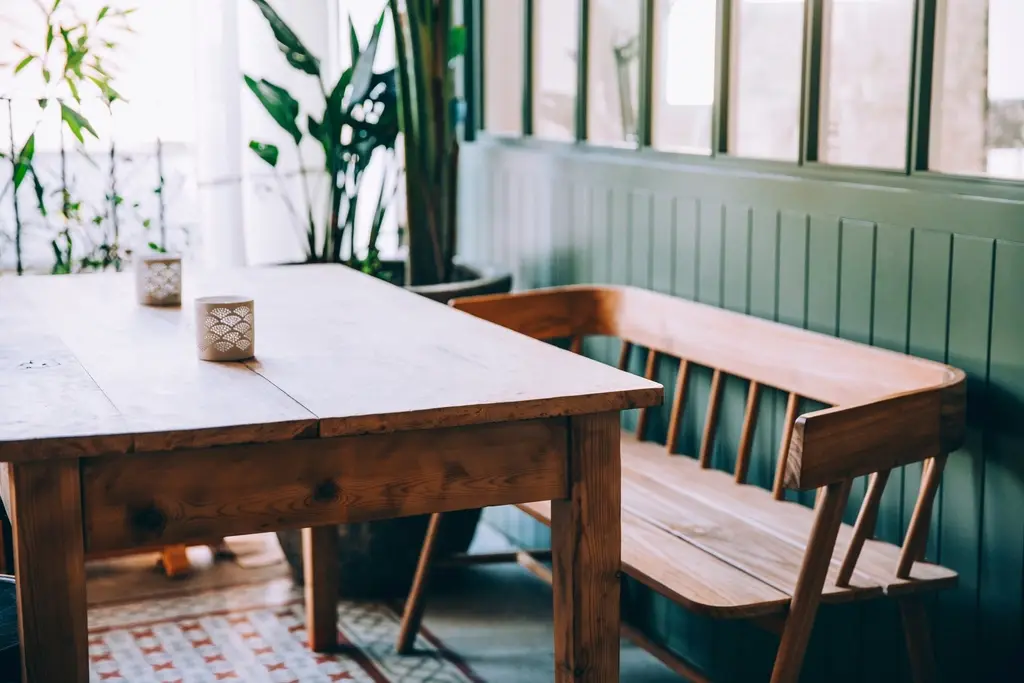 Wooden tables and benches by a bright window