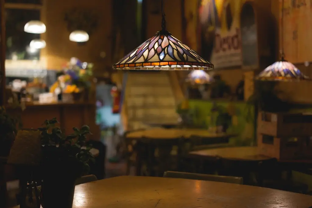 Warm hanging lamps over wooden tables