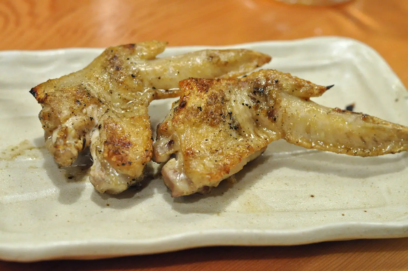 Grilled chicken wings on a white plate
